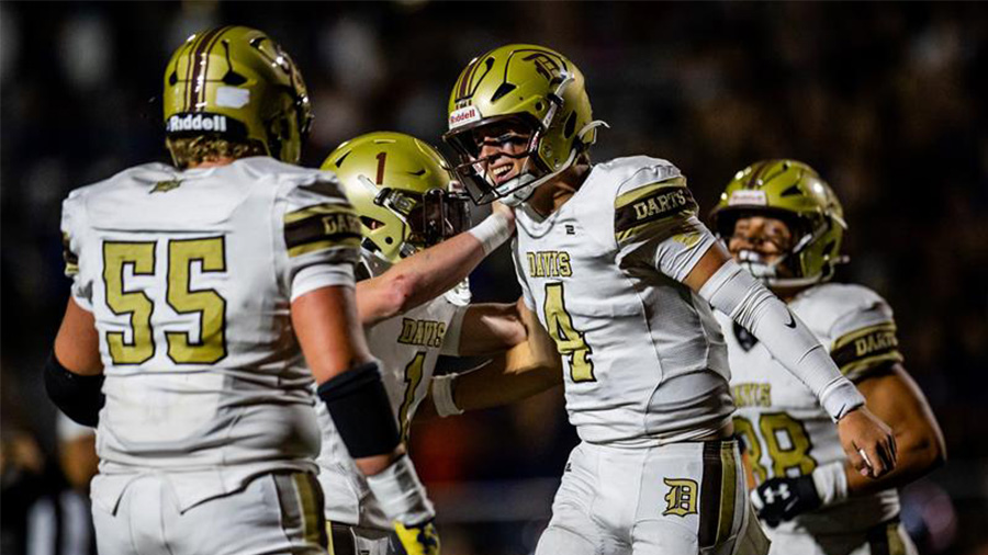 davis players celebrate on football field...
