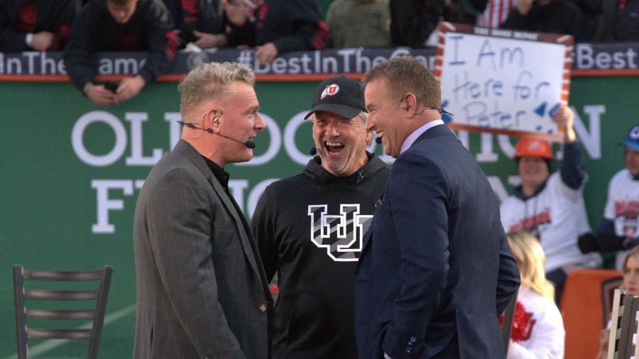 ESPN analysts Pat McAfee and Kirk Herbstreit laugh with Utah head coach Kyle Whittingham. (KSL Spor...