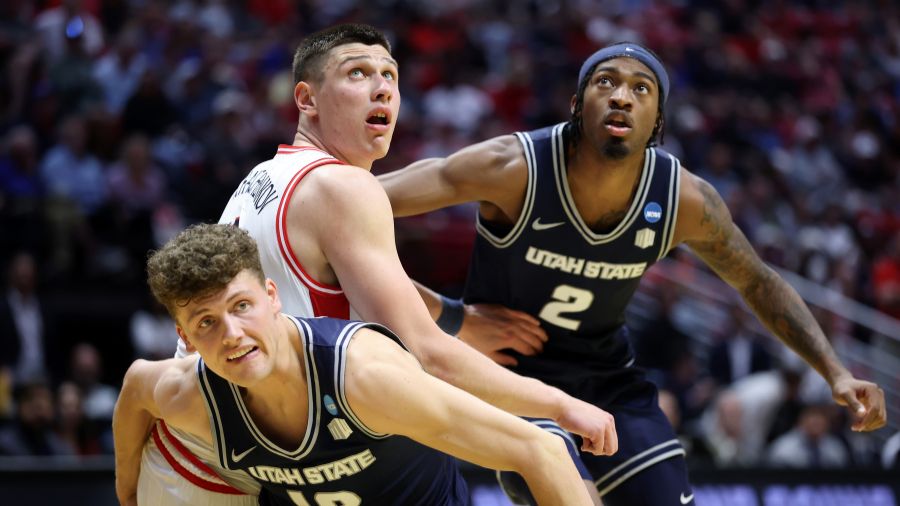 Mason Falslev #12 and MJ Collins #2 of the Utah State Aggies...