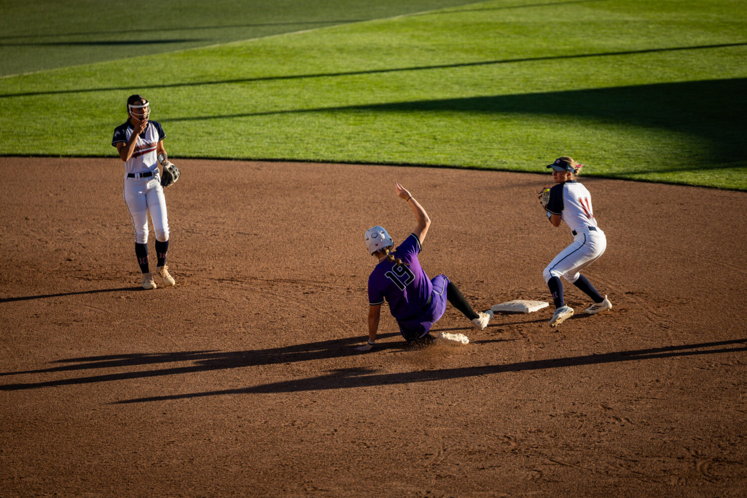 Riverton Silverwolves' Maggie Hamblin (19) gets out before making it to second base during Game 1 o...