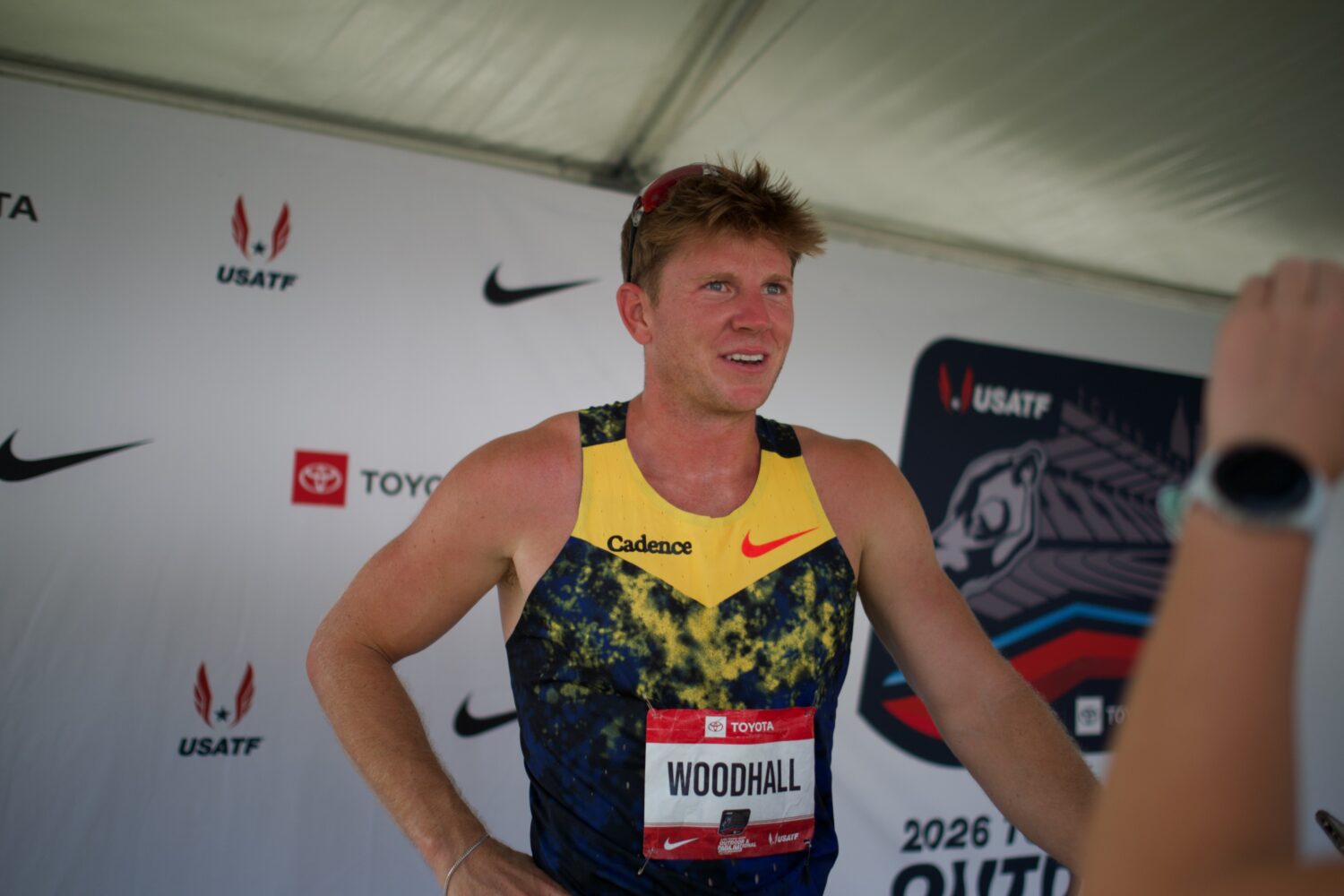 Former Syracuse High star and Paralympic medalist Hunter Woodhall speaks with the media in the mixe...