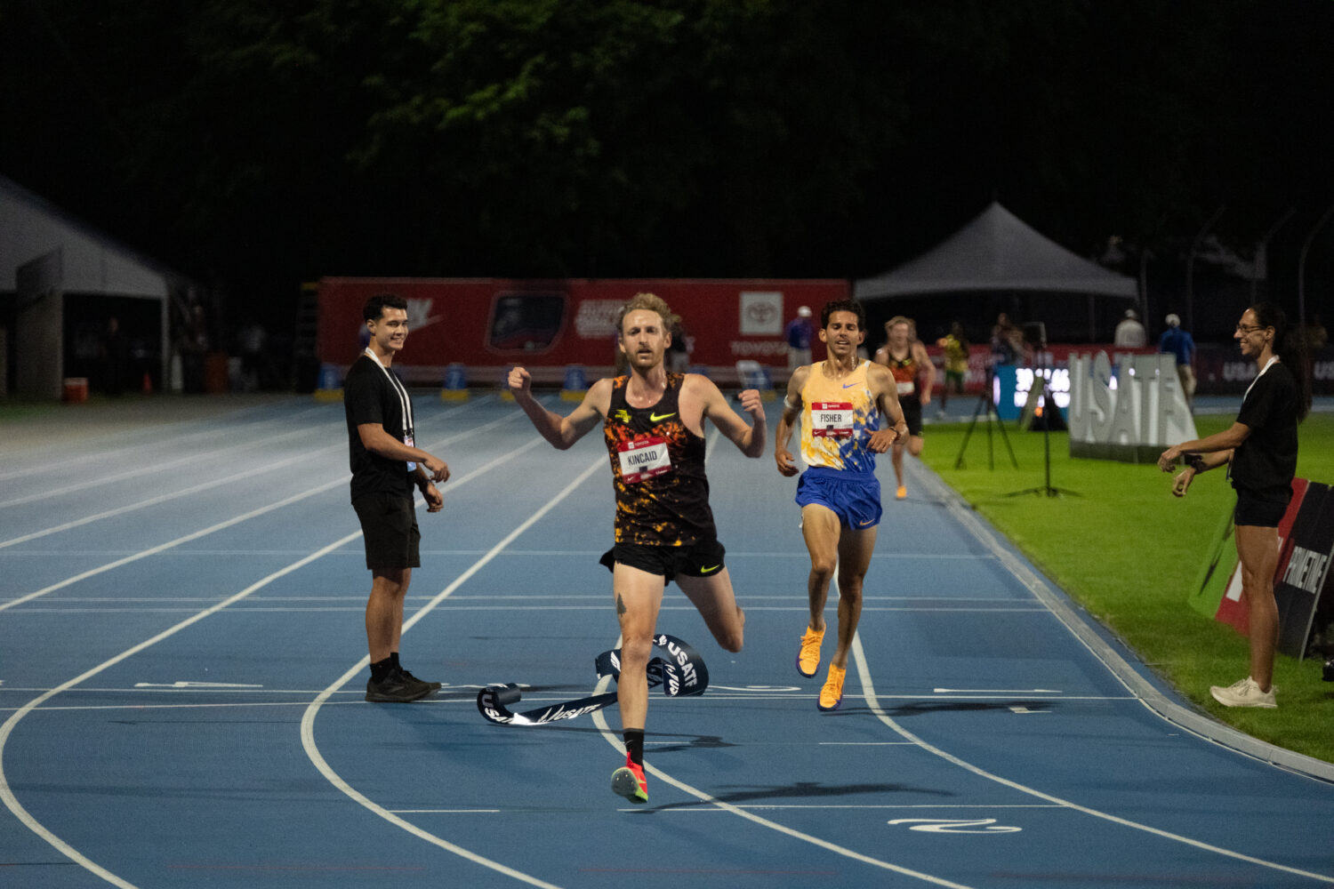 Woody Kincaid starts his final kick against Park City's Grant Fisher in the 10,000-meter final at t...