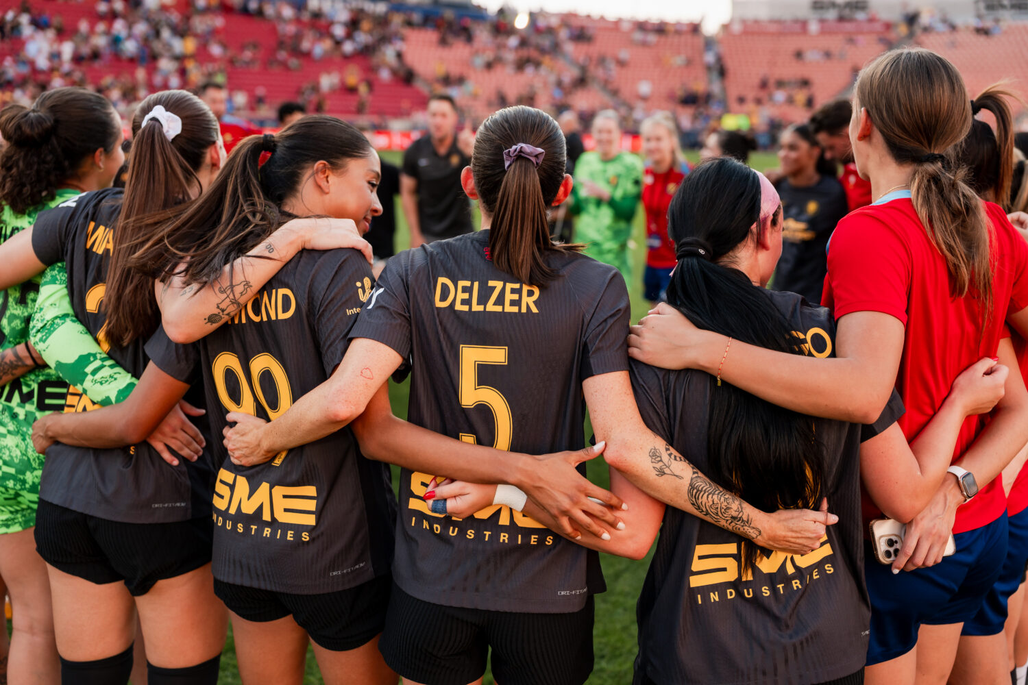 Cece Delzer huddles with her Utah Royals teammates after a 5-1 win over Portland Thorns FC, Sunday,...