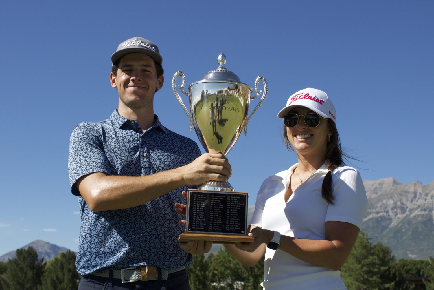 Former Utes golfer Blake Tomlinson holds the trophy with his girlfriend and caddy Kate after winnin...