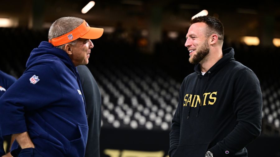 Head coach Sean Payton of the Denver Broncos speaks with Taysom Hill...