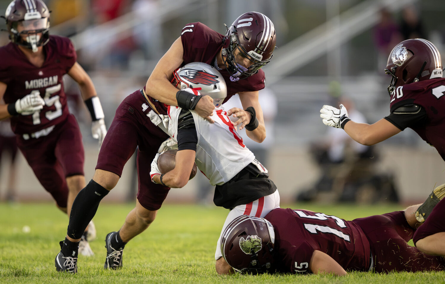 Morgan’s Kwayde Meibos and Jaxton Morrell smash Bountiful’s Max Feller on a kick return as they...
