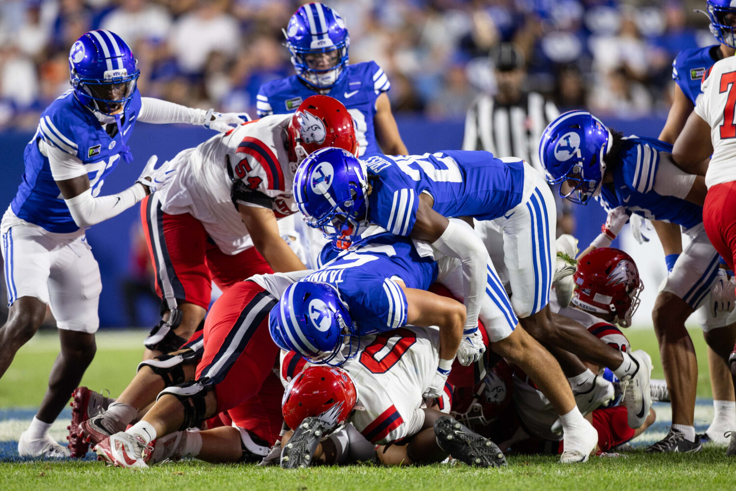 BYU defenders stuff Utah Tech Trailblazers running back Ace Chatman (0) at the line during a game a...