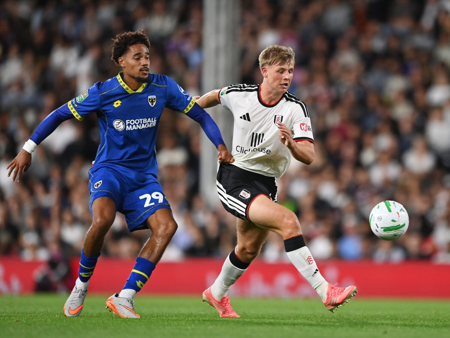 LONDON, ENGLAND - AUGUST 27: Luc De Fougerolles of Fulham is challenged by Aron Sasu of AFC Wimbled...
