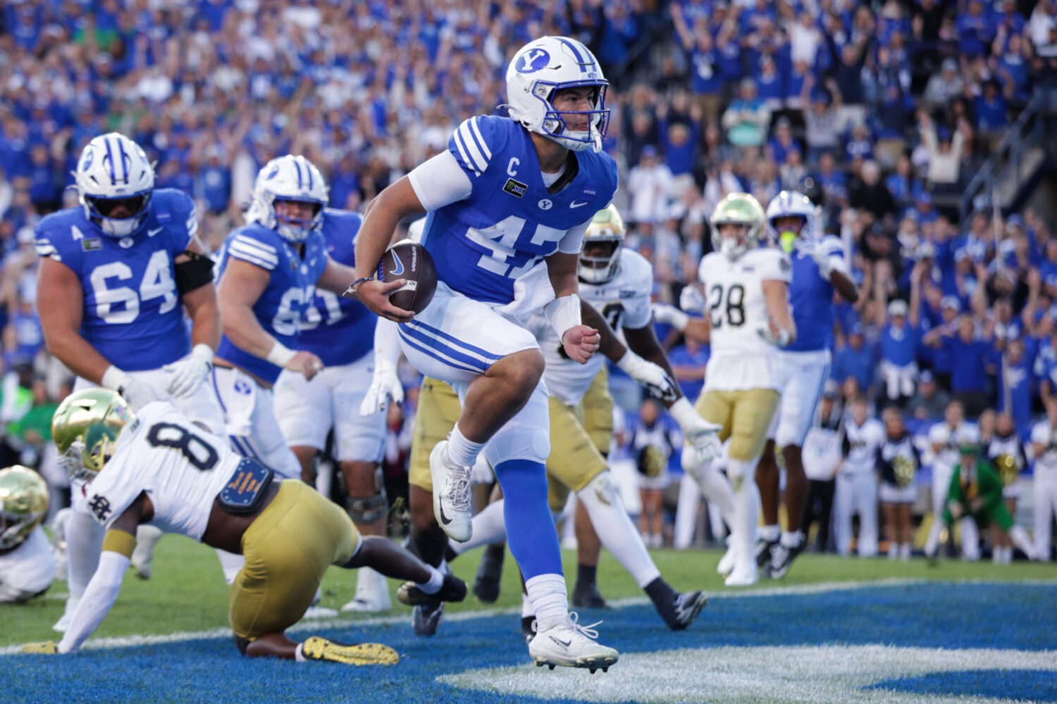 BYU Cougars quarterback Bear Bachmeier (47) runs in a touchdown during the first half of a  footbal...