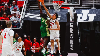 Utah basketball's Alec Anigbata blocks a shot vs Oregon....