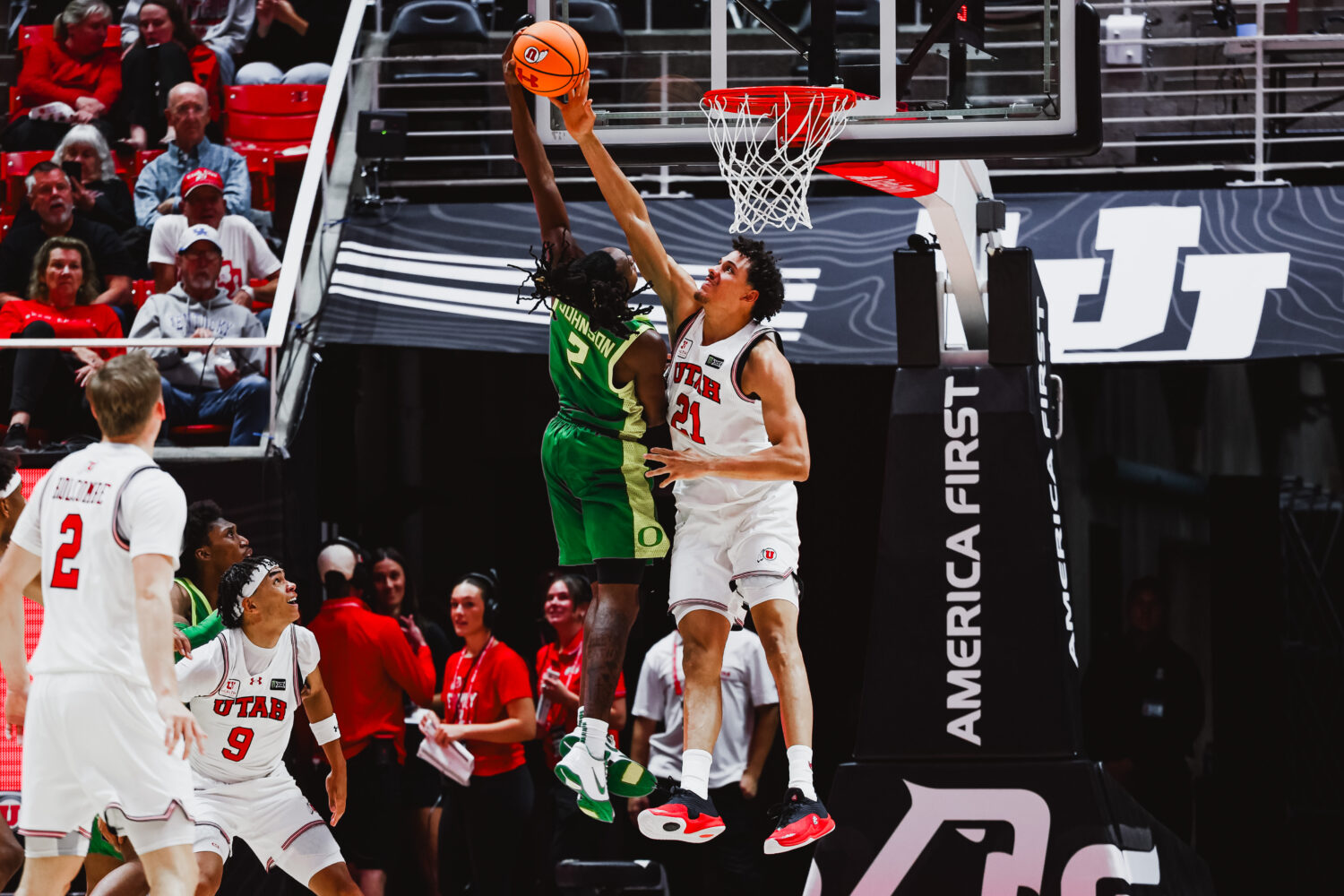Utah basketball's Alec Anigbata blocks a shot vs Oregon....